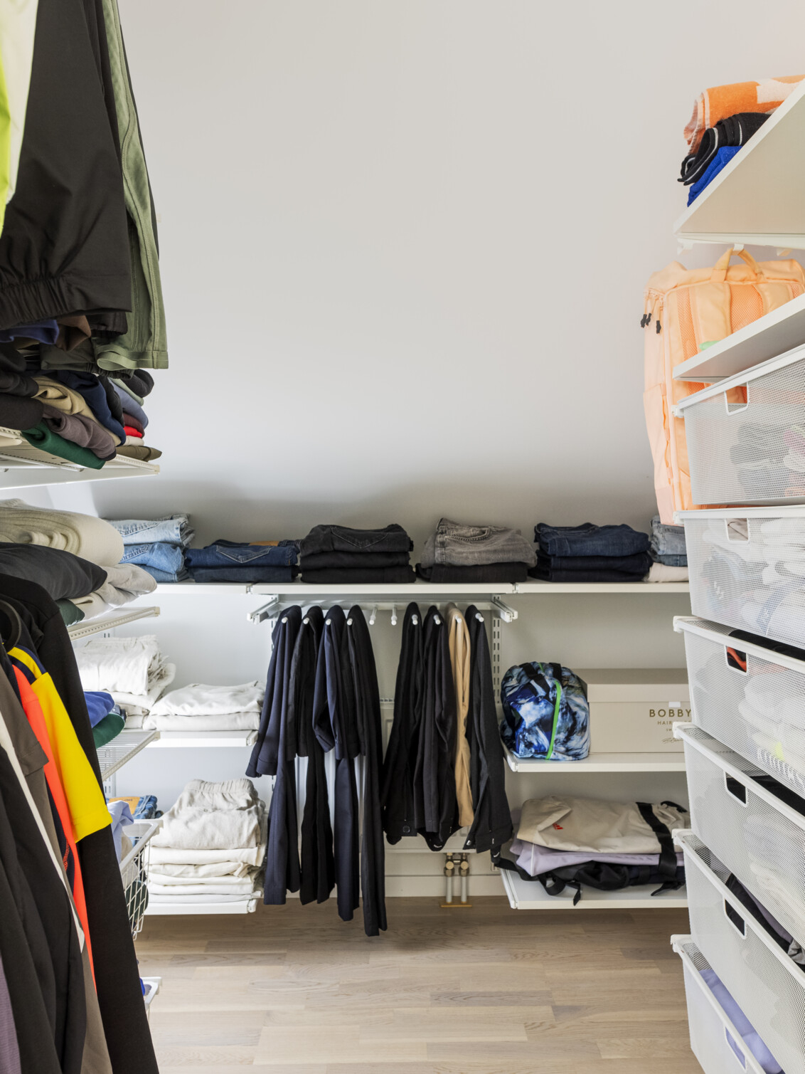 Classic by Elfa -vaatekaappi, jossa on säilytystilaa, roikkuvia vaatteita, ulosvedettäviä verkkokoreja ja housukoukku.