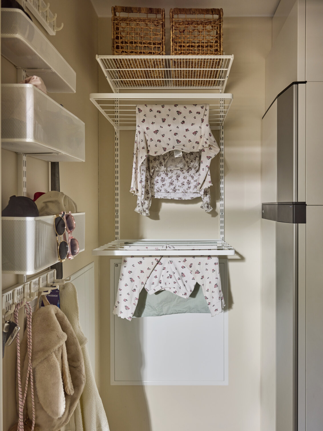 Laundry room with Classic by Elfa storage in white with drying shelves where clean laundry hangs.