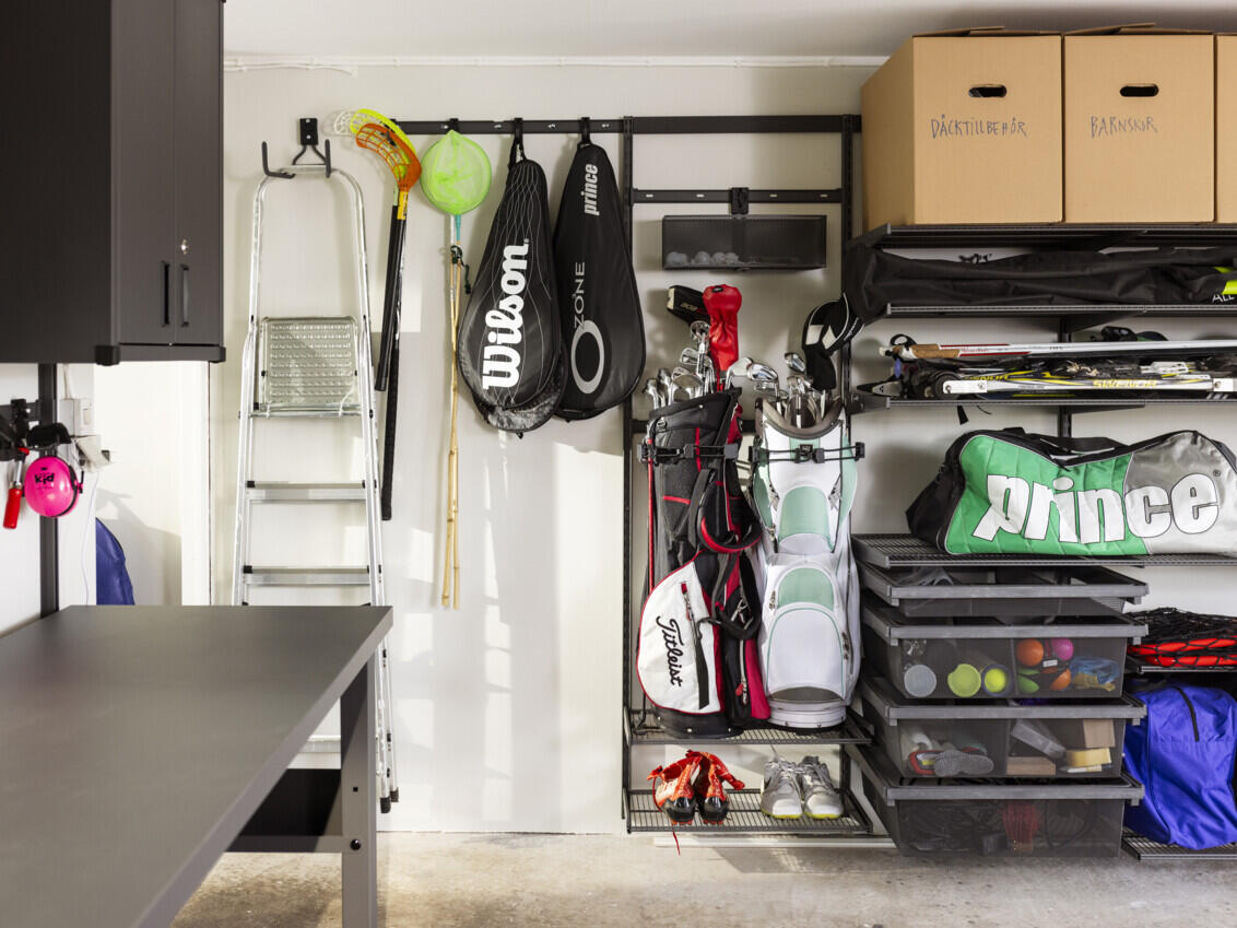Garage with Garage+ storage from Elfa used for hanging sports equipment such as golf clubs, tennis rackets and skis.
