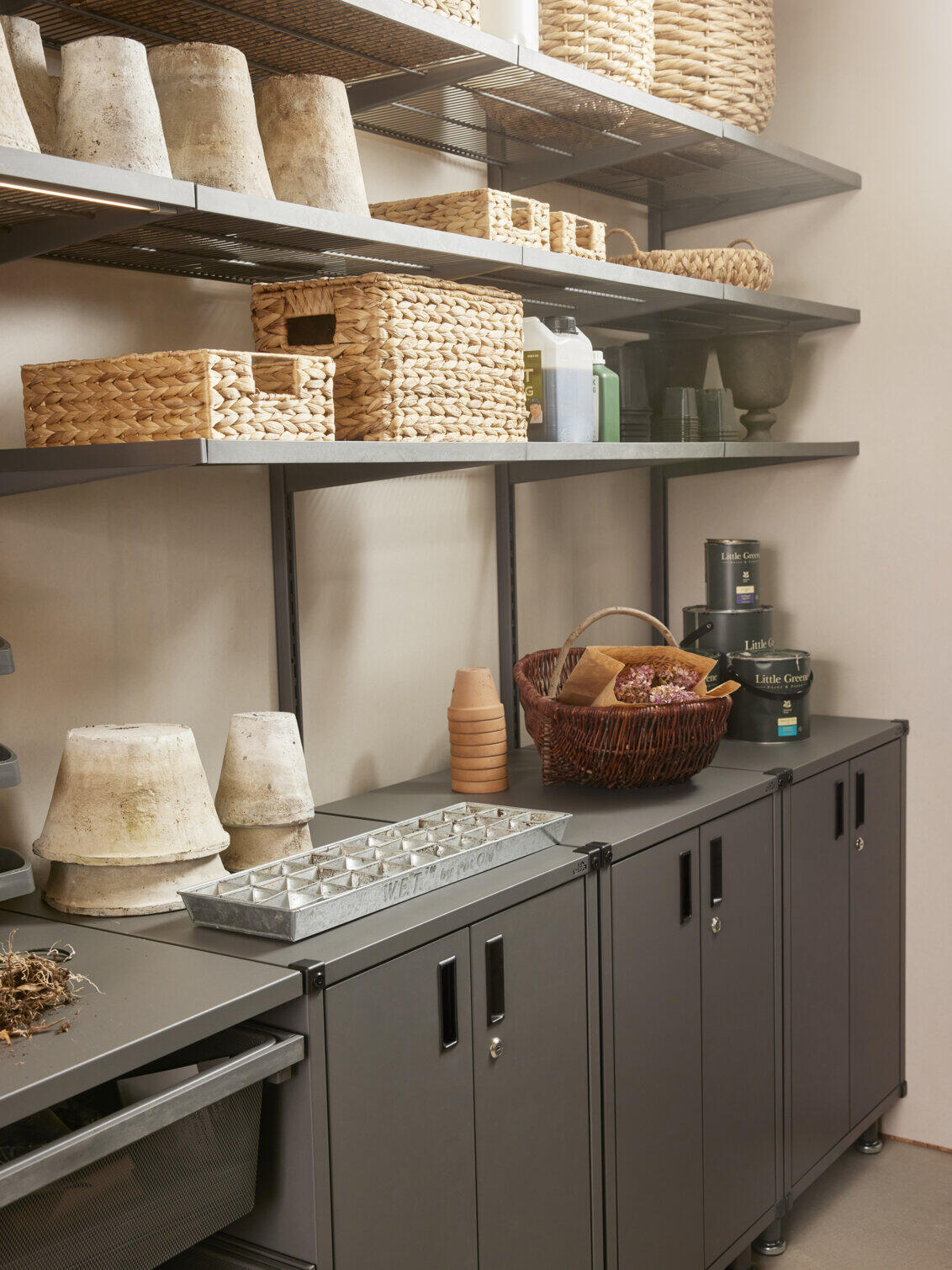 Storeroom with Garage+ storage from Elfa with wire shelves and lower cabinets for storing baskets and pots.