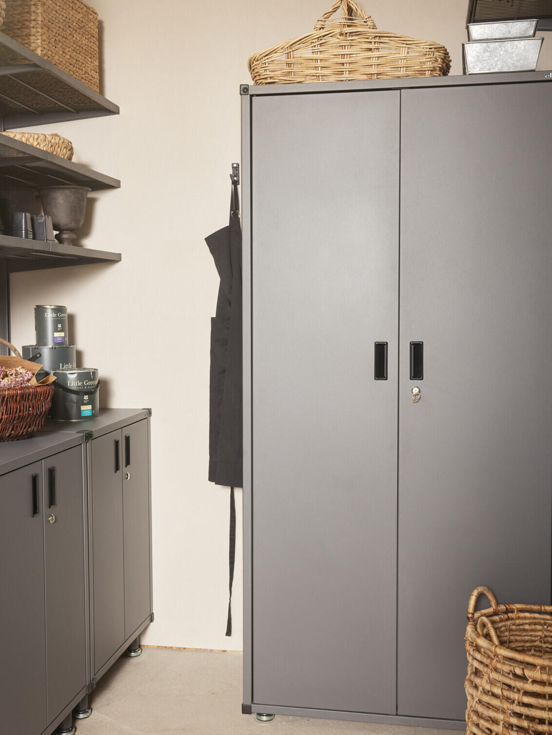 Storeroom with Garage+ tall cabinet from Elfa surrounded by baskets.