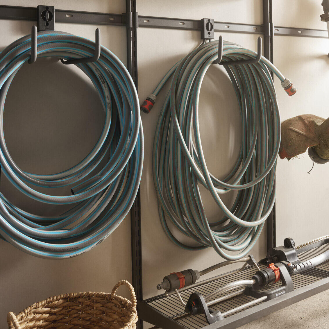Garage+ storage track from Elfa for hanging garden hoses.