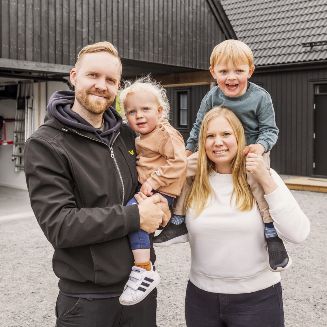 A family with young children playing bandy in a garage with Garage+ by Elfa storage.
