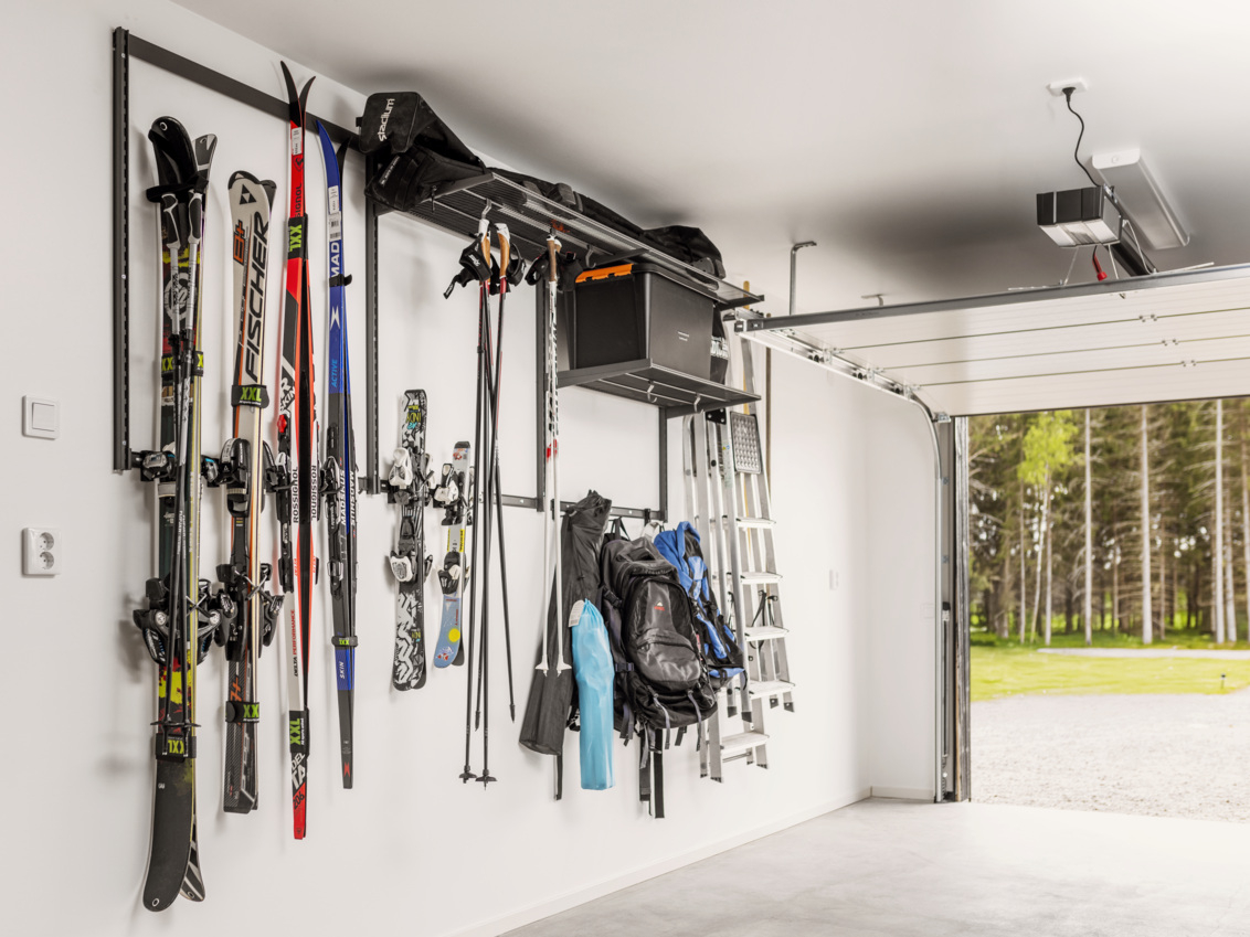 A garage with Garage+ by Elfa storage where skis and sports equipment are hung.