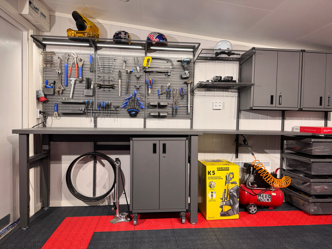 Garage with Garage+ by Elfa storage, with storing boards, cabinets and workbenches.