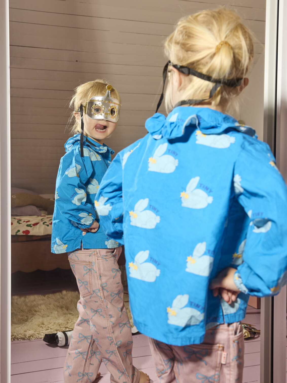 Estrid mirrors herself with a mask over her eyes.