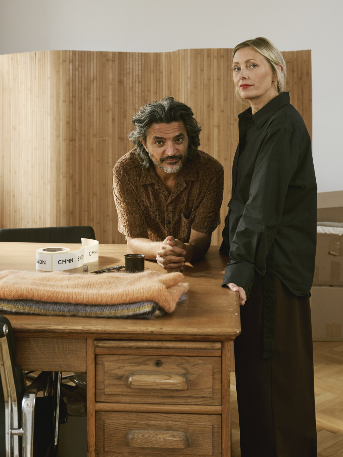 Emma and Saif in their study with a solid wooden desk.