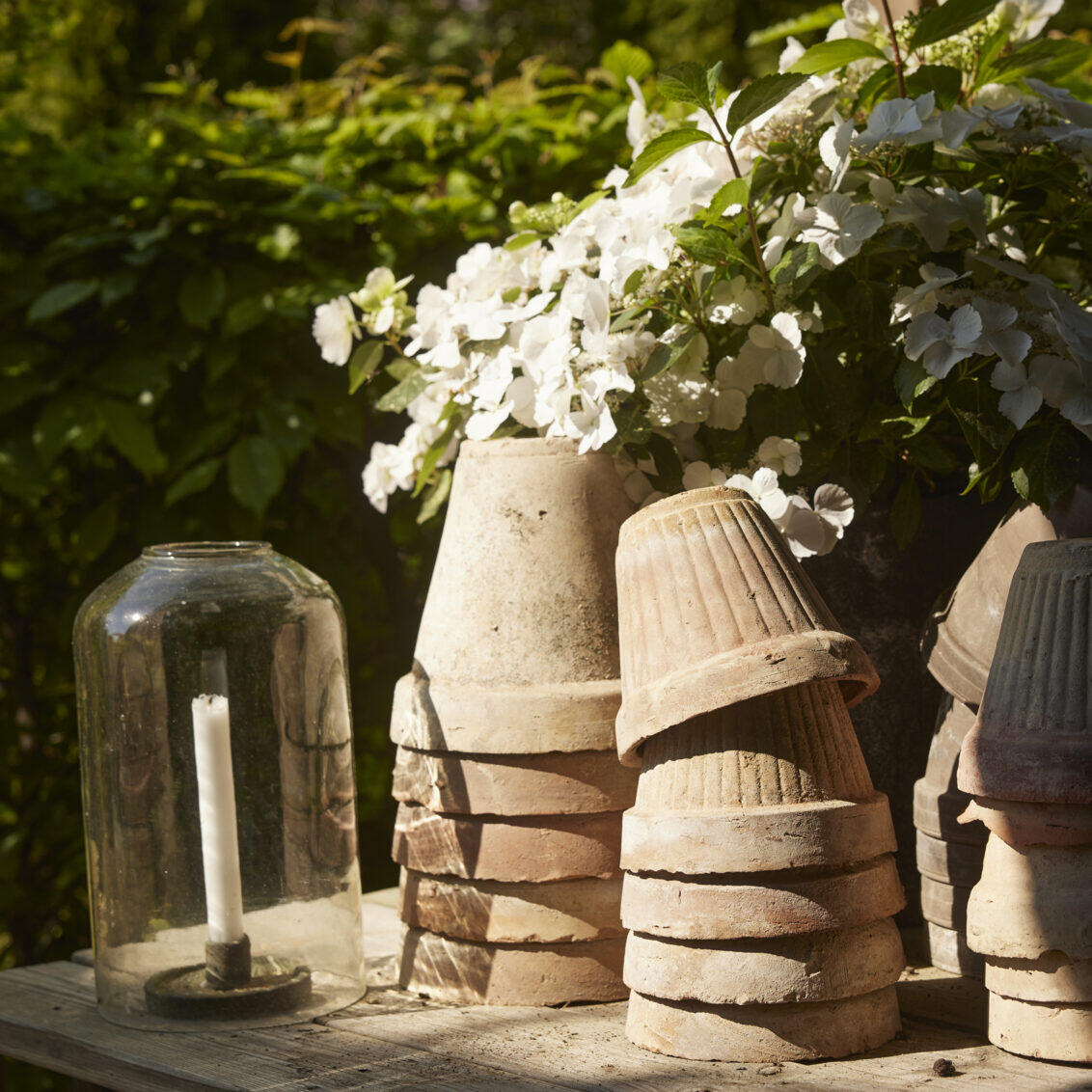 Upside down pots stacked on a wooden decking.