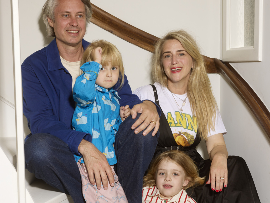 The family sits together on a staircase.