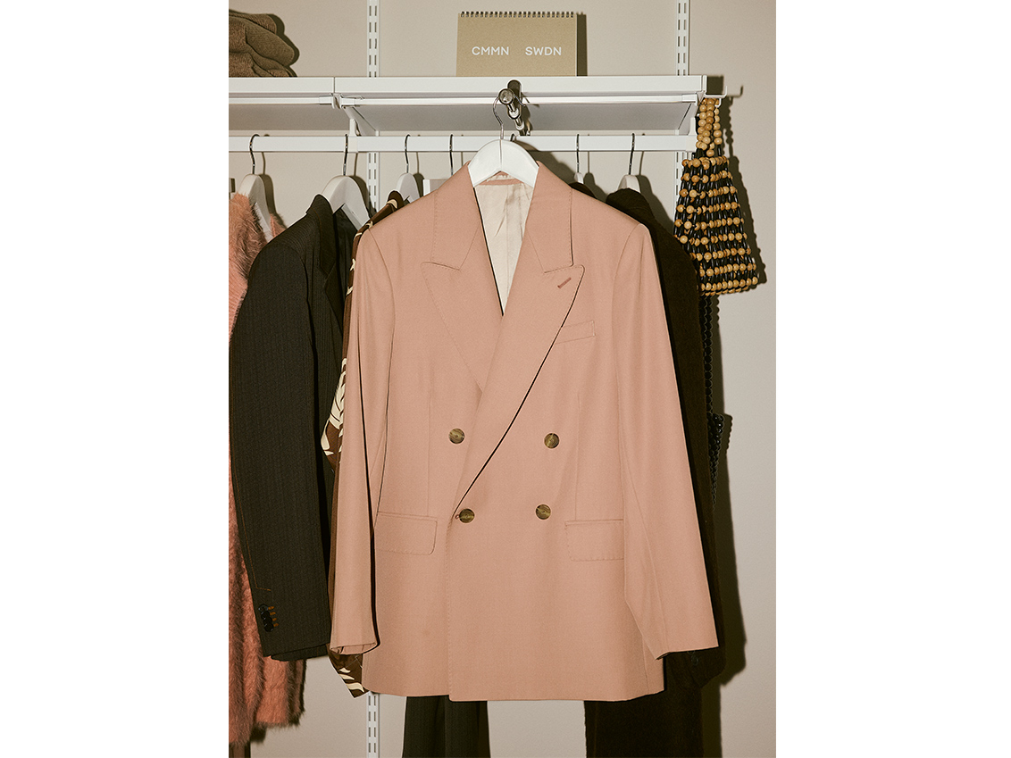 A pink blazer hangs in a Décor+ by Elfa wardrobe.