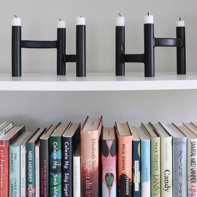 Bookcase with wall-mounted shelves with books and trinkets