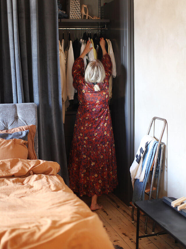 Wardrobe with clothes in bedroom