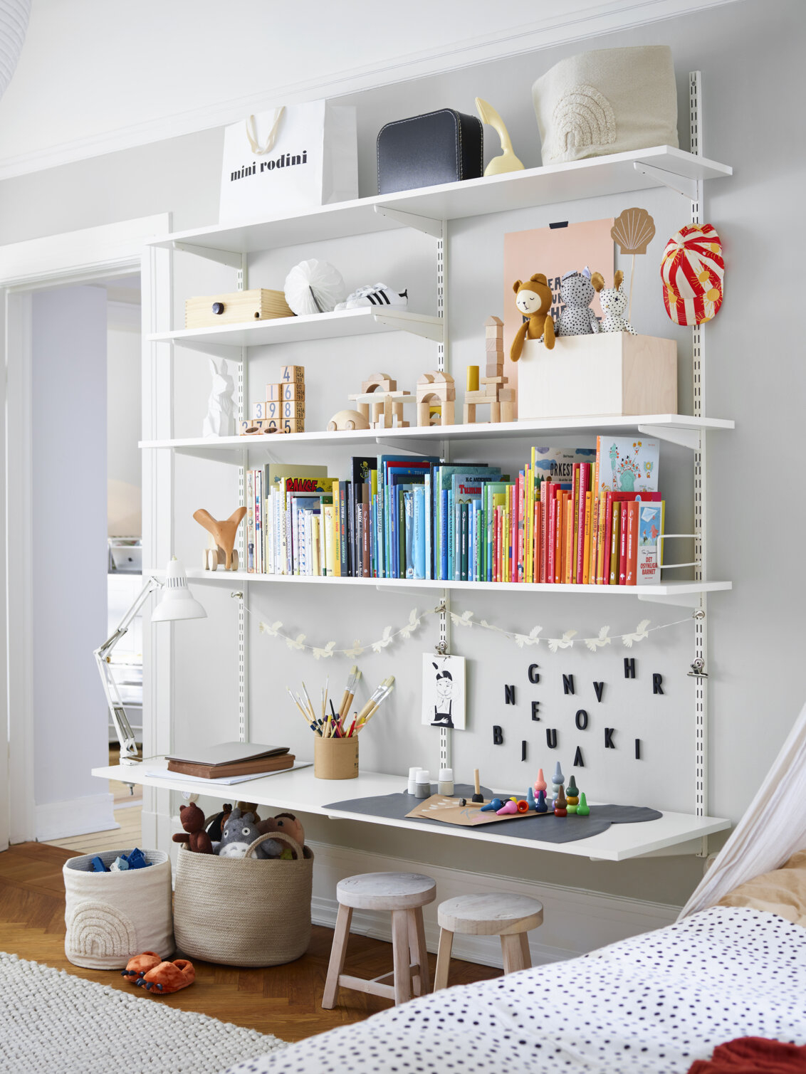 Lastenhuone, jossa on valkoinen Sparring by Elfa -kirjahylly, jonka alahylly toimii työpöytänä.