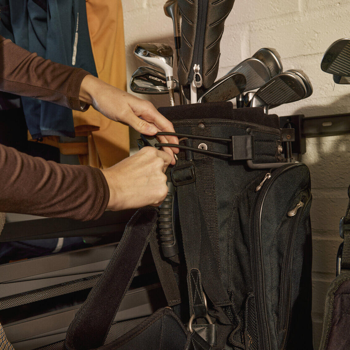 Los soportes para bolsas de golf Elfa crean orden y liberan espacio en el piso. Solución perfecta para organizar equipos de golf de forma inteligente y sencilla.