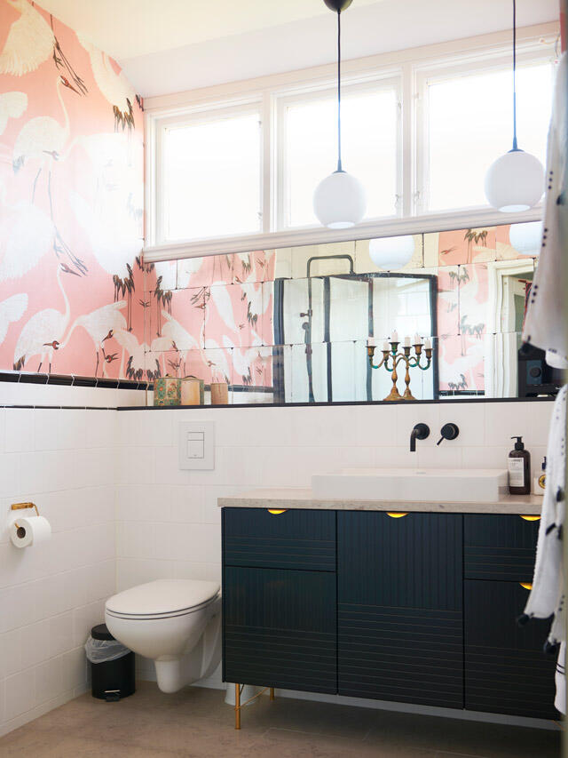 Pre-Elfa solution bathroom with pink wallpaper, black cabinets and white walls