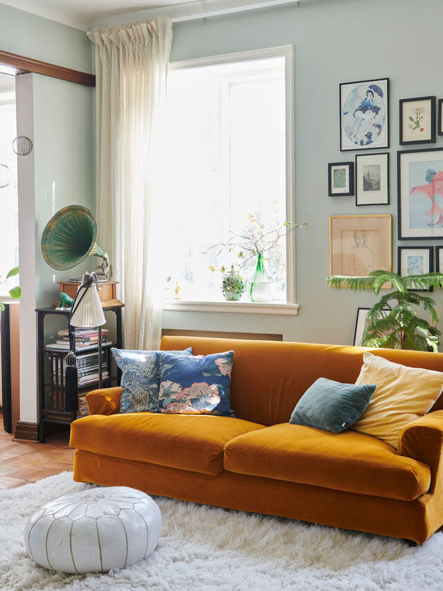 Living room before Elfa solution with mustard yellow velvet sofa and mint green walls