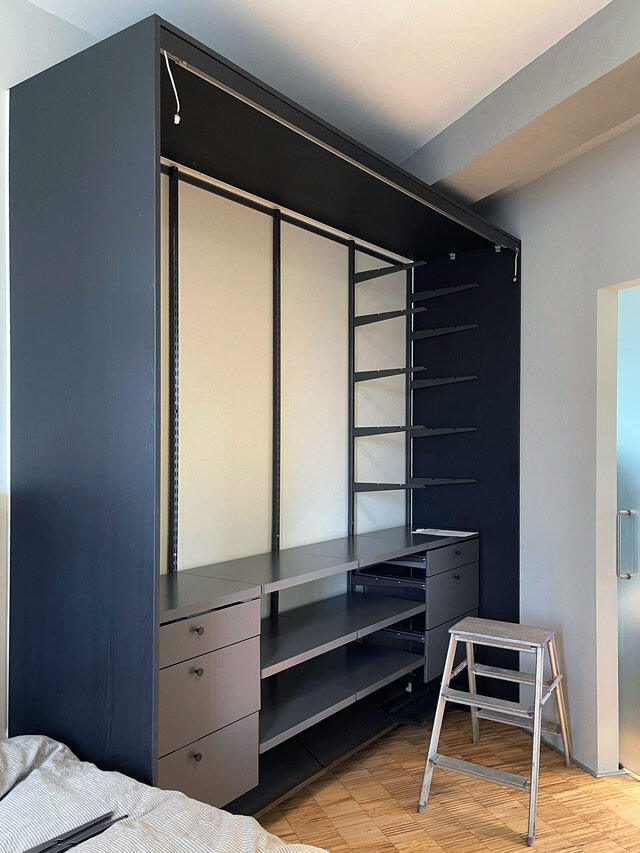 Modern Elfa wardrobe solution in dark finish with integrated shelves and drawers