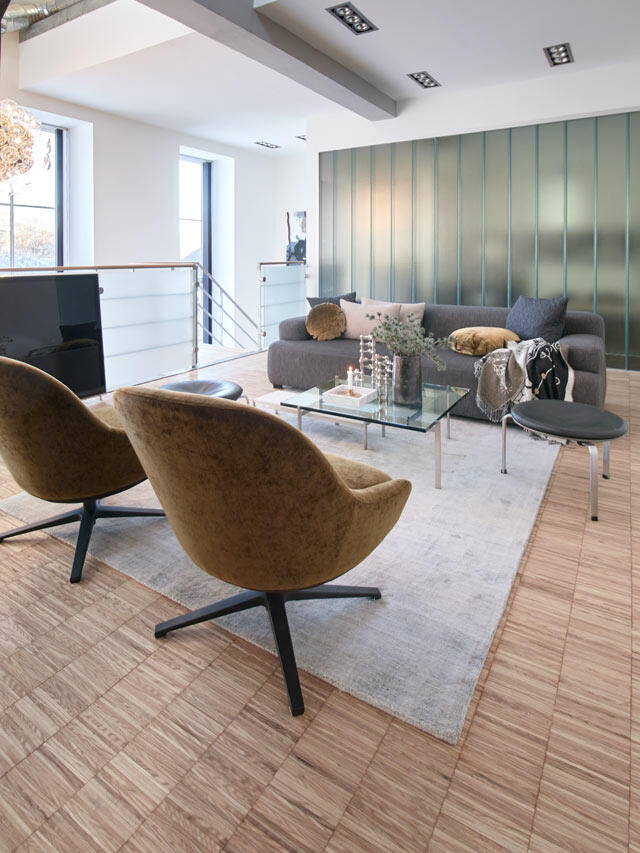 Living room with green accent wall and glass table