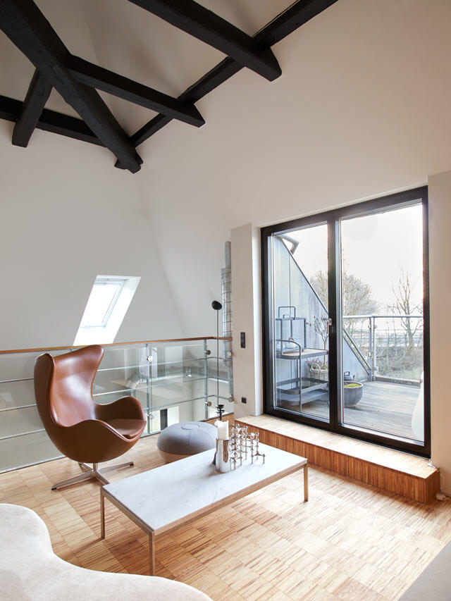 Bright loft space with hardwood floors and large windows, pre-organization