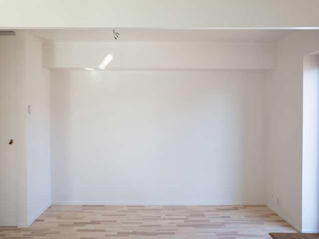 Empty white room with wooden floors, perfect for bespoke storage setup