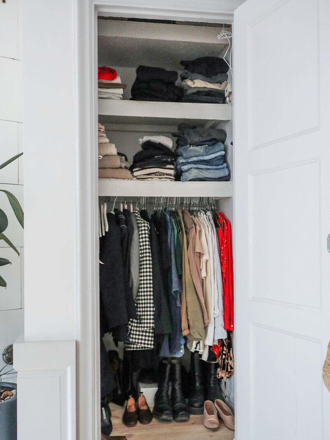 Emma Elwin Compact wardrobe with stacked clothes, hanging clothes and shoes, requires better organization
