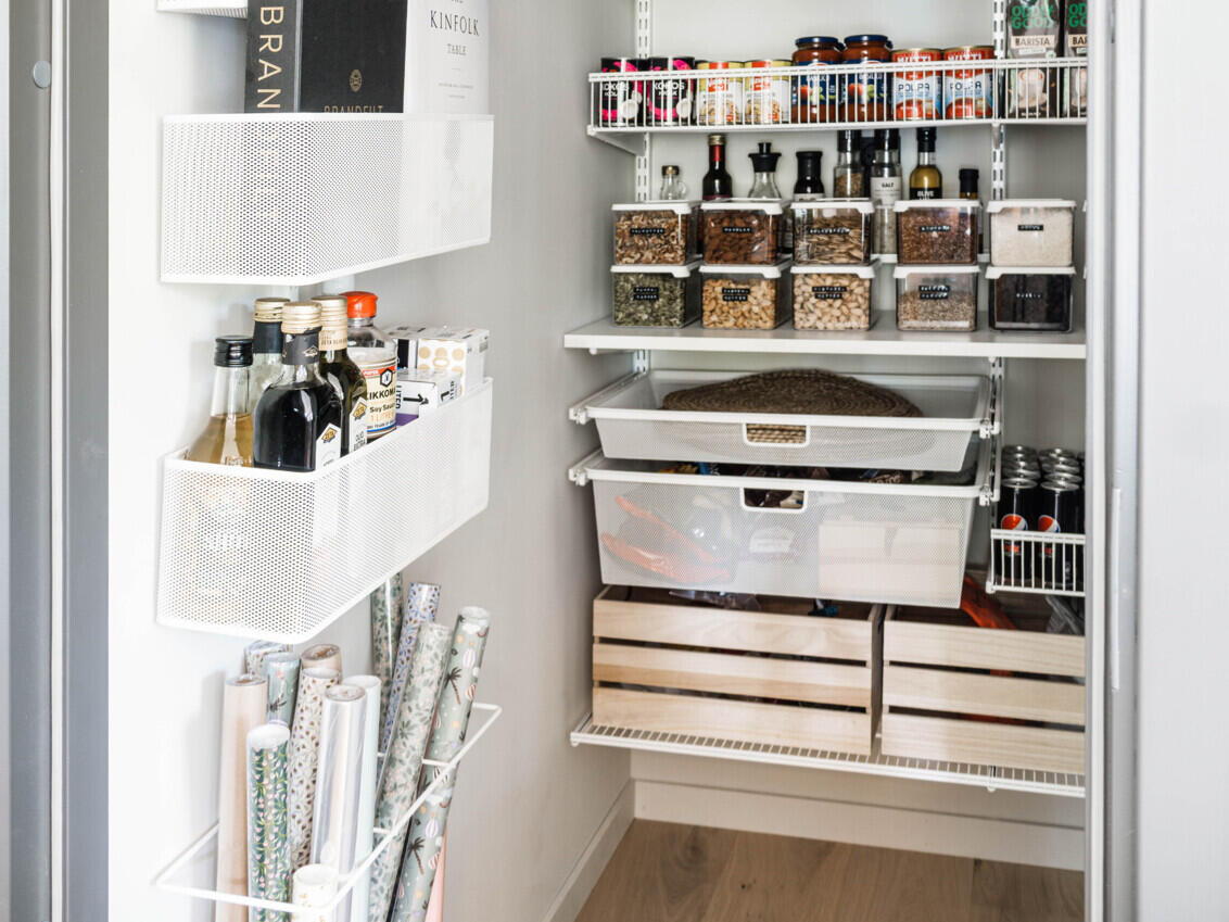 Kaappi, jossa on Classic by Elfa -säilytyskaluste, jossa on hyllyt, verkkokorit, lankakorit ja ovisäilytys.