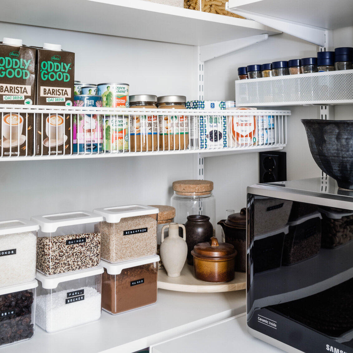 Elfa pantry with wire basket shelves and labelled dry goods storage