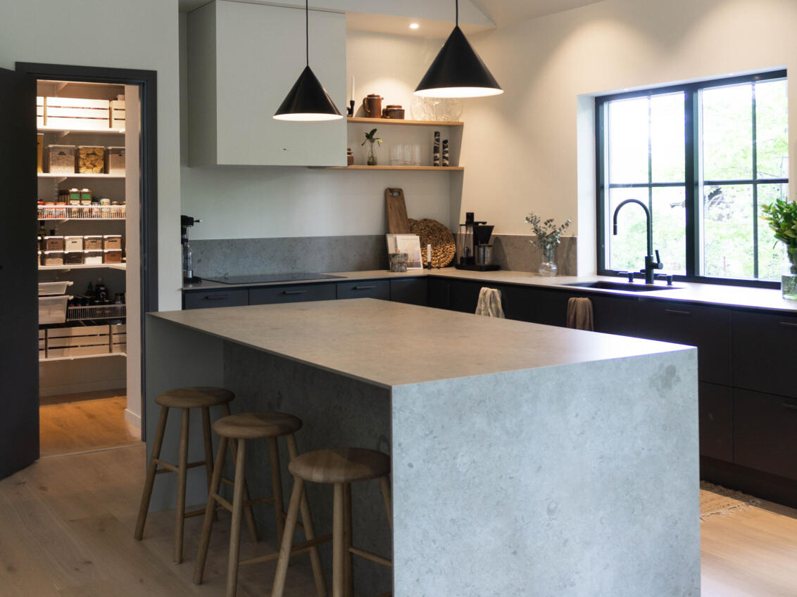 Modern kitchen with Elfa pantry visible through doorway