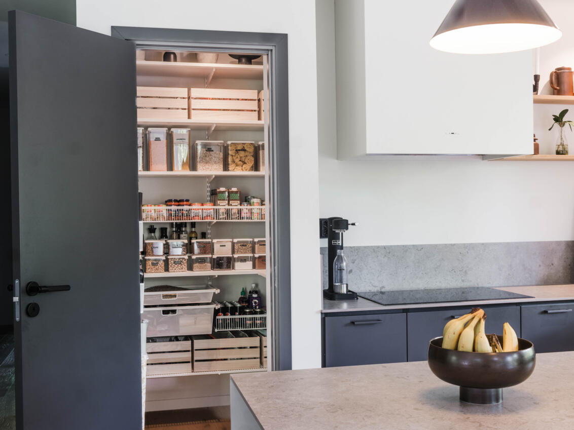 modern kitchen with Elfa pantry visible through doorway