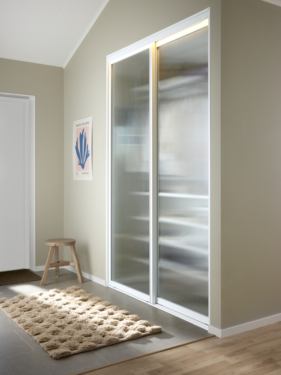 Hall med Classic by Elfa-garderobe som har skyvedørene Artic med linjeglass.