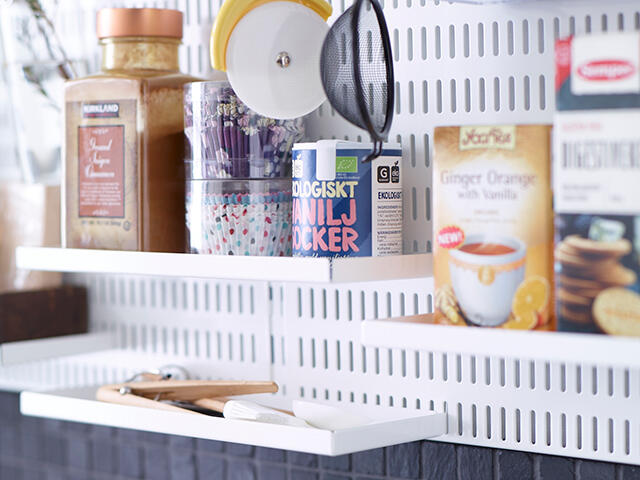 Storage of dry goods in the kitchen on a storage board in baskets.