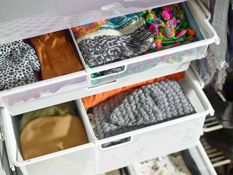 Storage in mesh basket with divider in white.