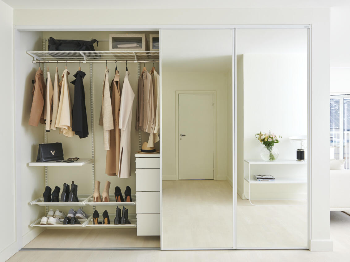 Wardrobe in master bedroom with sliding doors in Original with glass filling and clothes storage.